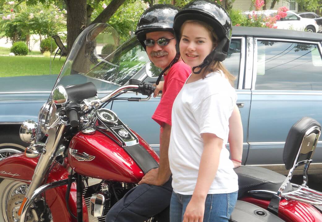 Wayne and daughter on a motorcycle